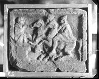 LOW RELIEF: two horsemen and a figure standing on altar 