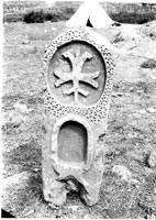 Gravestone in the form of stele with relief cross in ornamented oval