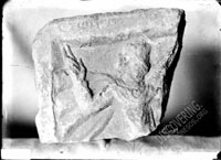 Fragment of gravestone depicting horseman with highly raised hand and inscription on top frame