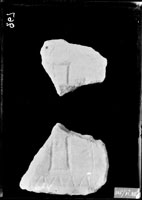 Two fragments of slab with incised image of cross within frame