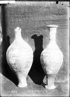 AMPHORISKOI (two), of black slip, with applied and scratched ornamentation