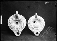 Late Roman lamps: with dotted ornamentation on the left, with shell (?) on the panel on the right
