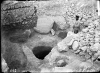 Pithoi in situ and cistern carved into bedrock 