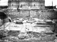 Ancient (Hellenistic) courtyard with well, pavement and remains of walls of adjoining rooms