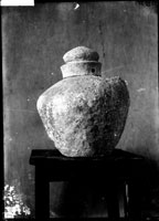 Lead urn with inscribed shoulders