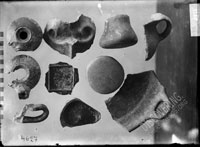 Fragments of VESSELS: red-slip plate bottom, black-slip vessel bottom with graffiti, fragment of clay cooking pan, fragments of handmade vessels from the 3rd layer in the roman house (termae?), room no. 1