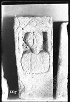 Gravestone in low relief with man's bust